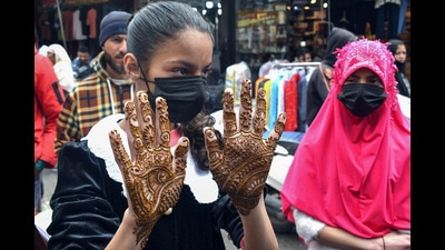 A girl shows her hand decorated with henna ahead of Eid at a market in Srinagar on Thursday. Incessant rainfall and cold weather dampened Eid festivities in Kashmir as a few shoppers were visible in the markets, especially in Srinagar city. (ANI) A girl shows her hand decorated with henna ahead of Eid at a market in Srinagar on Thursday. Incessant rainfall and cold weather dampened Eid festivities in Kashmir as a few shoppers were visible in the markets, especially in Srinagar city. (ANI)