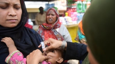 A health worker administers polio vaccine drops to a child at a railway station during a vaccination campaign in Karachi. (AFP) A health worker administers polio vaccine drops to a child at a railway station during a vaccination campaign in Karachi. (AFP)