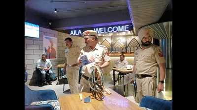 Police seizing hookahs from Alif Laila bar in Sector 11, Panchkula, on Wednesday night. (Sant Arora/HT)