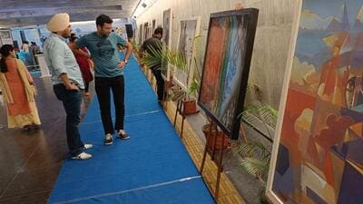 Visitors taking a look at the artworks on display (HT Photo)