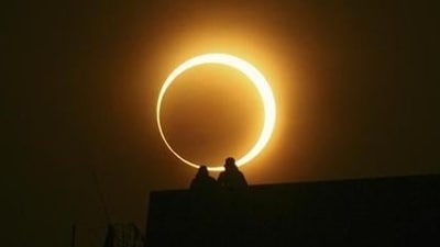 During the hybrid solar eclipse, people witness the sun forming a ring shape -‘ring of fire’- for a few seconds around the moon. (File Photo / Reuters)