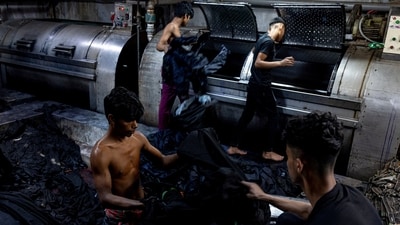 Factory workers wash and dry jeans in Dhaka, on April 8. Bangladesh is the world's second-biggest garment exporter after China but citizens and environment activists say the booming industry is also a major contributor to the ecological decline of the river, reports Reuters.&nbsp; (Mohammad Ponir Hossain / Reuters)