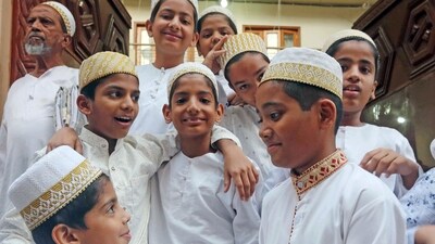 Devotees of the Dawoodi Bohra Community exchange greetings after offering prayers on the eve of Eid-al-Fitr, in Bhopal on Friday. (ANI) Devotees of the Dawoodi Bohra Community exchange greetings after offering prayers on the eve of Eid-al-Fitr, in Bhopal on Friday. (ANI)