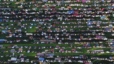 People attend Eid Ul-Fitr prayer at a stadium in the city of Idlib, Syria on Friday. (AP) People attend Eid Ul-Fitr prayer at a stadium in the city of Idlib, Syria on Friday. (AP)