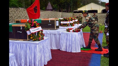 An army officer lays a wreath near the mortal remains of 5 soldiers who were killed in a terrorist attack in Poonch district, Friday. (PTI)