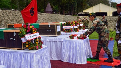 An army officer lays a wreath near the mortal remains of 5 soldiers who were killed in a terrorist attack in Poonch district, Friday. (PTI) (HT_PRINT) An army officer lays a wreath near the mortal remains of 5 soldiers who were killed in a terrorist attack in Poonch district, Friday. (PTI) (HT_PRINT)