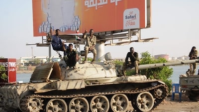 Sudanese army soldiers, loyal to army chief Abdel Fattah al-Burhan, sit atop a tank in the Red Sea city of Port Sudan, on April 20, 2023. (Photo by AFP) Sudanese army soldiers, loyal to army chief Abdel Fattah al-Burhan, sit atop a tank in the Red Sea city of Port Sudan, on April 20, 2023. (Photo by AFP)