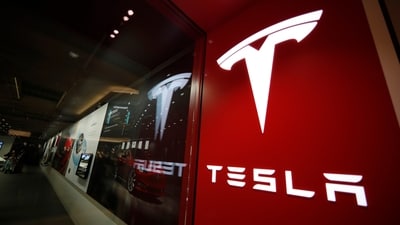 A sign bearing the Tesla company logo is displayed outside a Tesla store. (AP) A sign bearing the Tesla company logo is displayed outside a Tesla store. (AP)