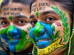 Moradabad: Young women with the messages painted on their faces urging to save the earth at a programme, on the eve of the Earth Day, in Moradabad, UP on Friday,(PTI)