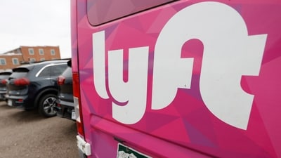 FILE - A Lyft ride-hailing vehicle is parked near Empower Field at Mile High in Denver on April 30, 2020. (AP Photo/David Zalubowski, File) FILE - A Lyft ride-hailing vehicle is parked near Empower Field at Mile High in Denver on April 30, 2020. (AP Photo/David Zalubowski, File)