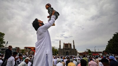 A man plays with his kid during Eid-ul-Fitr prayers at Eidgah ground to mark the end of the holy fasting month of Ramadan, in Jammu. (PTI) A man plays with his kid during Eid-ul-Fitr prayers at Eidgah ground to mark the end of the holy fasting month of Ramadan, in Jammu. (PTI)