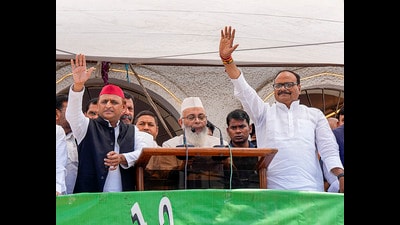 Uttar Pradesh deputy Chief Minister Brajesh Pathak and Samajwadi Party President Akhilesh Yadav greet muslims on the occassion of Eid-ul-Fitr, at Eidgah in Lucknow on Saturday. (PTI)