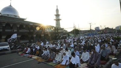 Muslims perform Eid prayers at the end of the month of Ramadan on a street in Bekasi, on the outskirts of Jakarta. (AP)