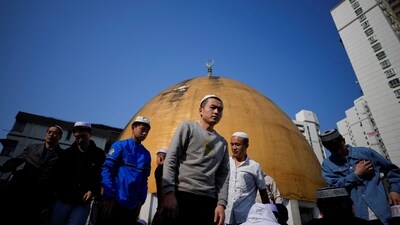 People in China's Shanghai reach a mosque nearby to attend Eid prayers. (Reuters)