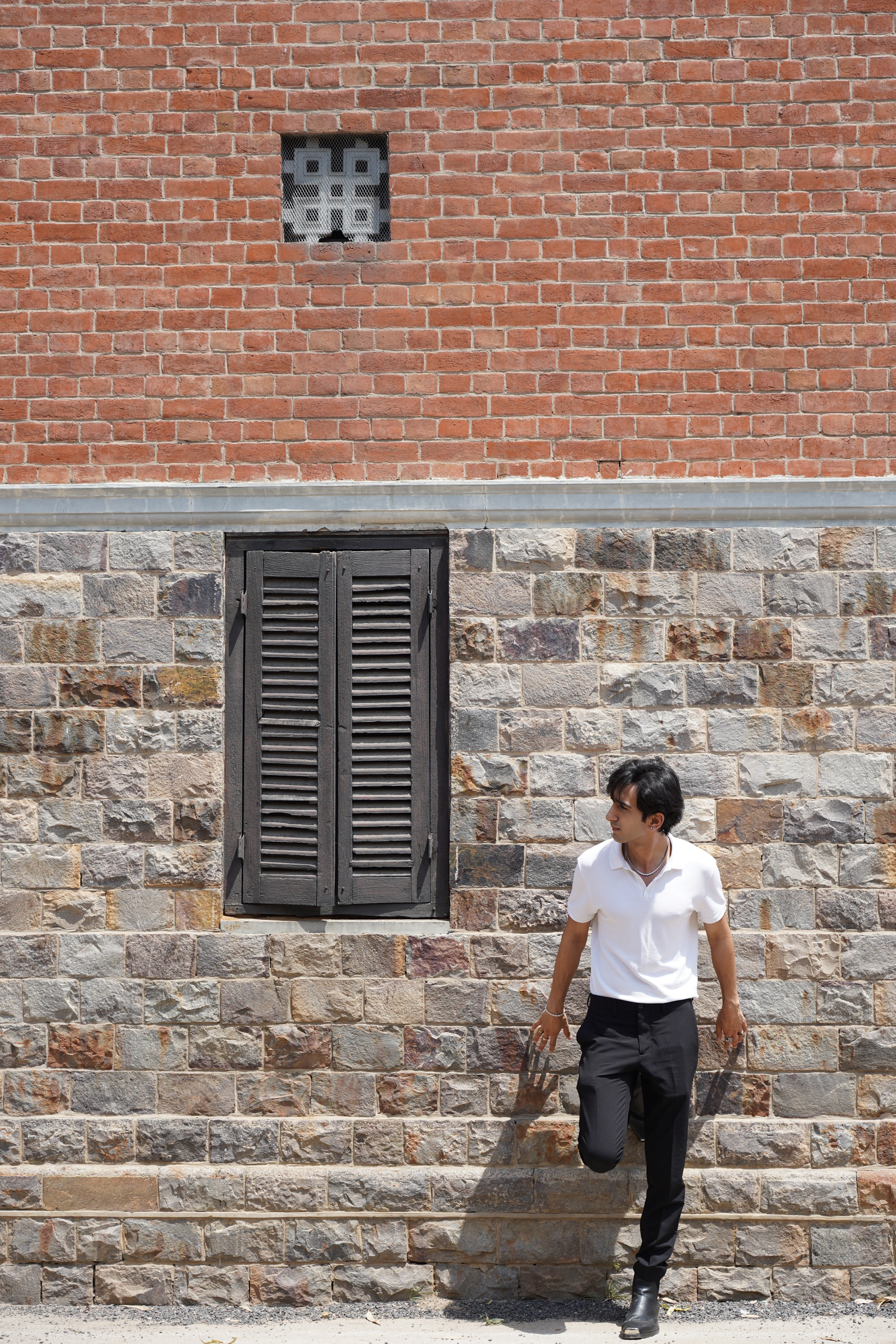Not another brick in the wall as Koul strikes a pose as he tours his alma materR. Not another brick in the wall as Koul strikes a pose as he tours his alma materR.