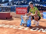Spain's Carlos Alcaraz poses with his trophy after beating Greece's Stefanos Tsitsipas during the ATP Barcelona Open