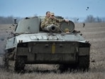 Ukrainian service members ride a self-propelled howitzer, as Russia's attack on Ukraine continues, near the front line city of Bakhmut, Ukraine April 7. 