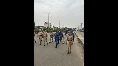 Police and Rapid Action Forces during flag march in Ludhiana on Sunday. (HT Photo)