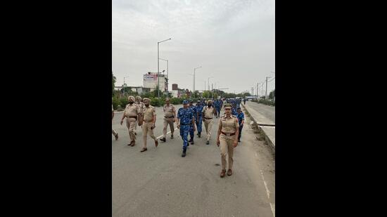 Police and Rapid Action Forces during flag march in Ludhiana on Sunday. (HT Photo)