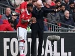 Manchester United's Dutch manager Erik ten Hag (R) gives instructions to Manchester United's Brazilian midfielder Fred