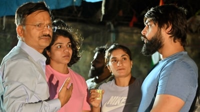 Sports Authority of India (SAI) Deputy Director Shiv Sharma with wrestlers Vinesh Phogat, Sakshi Malik and Satyawart Kadian during the wrestlers' protest against the Wrestling Federation of India (WFI) chief Brij Bhushan Singh, at Jantar Mantar in New Delhi on Monday. (ANI Photo) Sports Authority of India (SAI) Deputy Director Shiv Sharma with wrestlers Vinesh Phogat, Sakshi Malik and Satyawart Kadian during the wrestlers' protest against the Wrestling Federation of India (WFI) chief Brij Bhushan Singh, at Jantar Mantar in New Delhi on Monday. (ANI Photo)