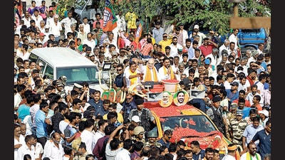 Home minister Amit Shah during a roadshow in Hassan on Monday. (ANI)