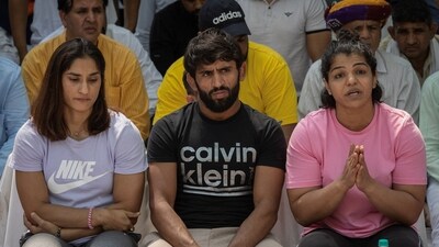 Indian wrestlers Vinesh Phogat, Bajrang Punia, and Sakshi Malik take part in a sit-in protest demanding arrest of Wrestling Federation of India chief in New Delhi (REUTERS)