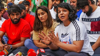 Bajrang Punia, Vinesh Phogat and  Sakshi Malik during a press conference regarding wrestlers' protest at Jantar Mantar in New Delhi Sunday, April 23, 2023. (PTI)