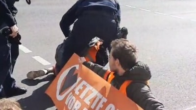 One man ran at a line of campaigners before he was pushed over by police. (Twitter/ @RaphaelThelen) One man ran at a line of campaigners before he was pushed over by police. (Twitter/ @RaphaelThelen)