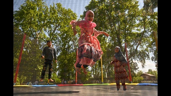 Children play on a trampoline in Srinagar on Monday. (AFP)