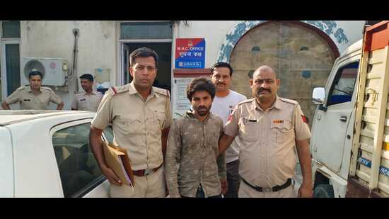 Police with the accused, identified as Vishal Sharma, following his arrest after fleeing from the Pinjore police station. (HT Photo)