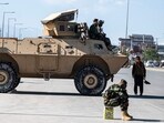 Taliban security personnel sit on an armoured vehicle outside the Eid Gah mosque in Kabul on April 20, 2023. (Photo by Wakil KOHSAR / AFP)