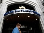 FILE PHOTO: A woman walks past the British American Tobacco offices in London, Britain October 21, 2016. REUTERS/Stefan Wermuth/File Photo