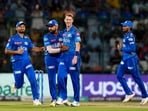 Mumbai Indians bowler Riley Meredith with teammate Rohit Sharma celebrate the wicket of Delhi Capitals batter Yash Dhull 