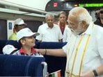 PM Modi with school kids onboard Vande Bharat Express train. 