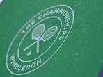 General view as rain drops are seen on a Wimbledon umbrella 