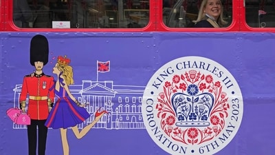 A tourist sits on a Coronation Tour Bus in London, Monday. (AP) A tourist sits on a Coronation Tour Bus in London, Monday. (AP)