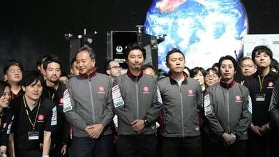 Takeshi Hakamada, center, founder and CEO of ispace, right, and his team staff gather for photo session after livestream of HAKUTO-R private lunar exploration program on screen at the lunar landing event Wednesday, April 26, 2023, at Miraikan, the National Museum of Emerging Science and Innovation, in Tokyo. (AP) Takeshi Hakamada, center, founder and CEO of ispace, right, and his team staff gather for photo session after livestream of HAKUTO-R private lunar exploration program on screen at the lunar landing event Wednesday, April 26, 2023, at Miraikan, the National Museum of Emerging Science and Innovation, in Tokyo. (AP)