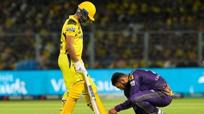 KKR bowler Varun Chakravarthy ties the shoe laces of Chennai Super Kings batter Ajinkya Rahane during IPL 2023 (PTI)