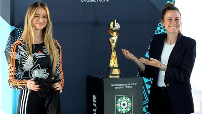 US player Heather O'Reilly and English freestyle competitor Lia Lewis reveal the FIFA Women’s World Cup trophy (REUTERS)