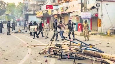 Security personnel detain people while trying to control the situation after violent protests over the death of a minor girl in North Dinajpur district, West Bengal, on Tuesday. (PTI)