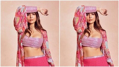 Malaika decked up in a pink sequined bralette and a matching pink georgette skirt with a silver sequin border at the waist. She added more oomph to her look with a dramatic pink floral shrug with pink sequin cuffs.&nbsp; (Instagram/@malaikaaroraofficial)