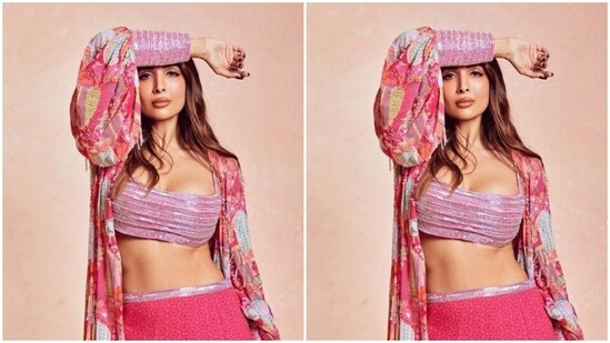Malaika decked up in a pink sequined bralette and a matching pink georgette skirt with a silver sequin border at the waist. She added more oomph to her look with a dramatic pink floral shrug with pink sequin cuffs.&nbsp;(Instagram/@malaikaaroraofficial)