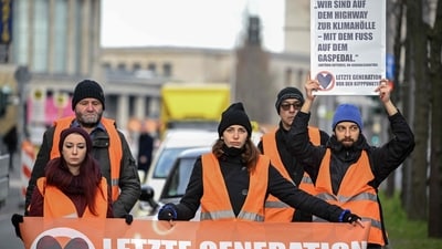 Activist Irma Trommer (C) of the environmental group "Last Generation" (Letzte Generation) takes part in an action to block a street as part of a protest for climate change on April 5, 2023 in Berlin's Charlottenburg district. (AFP) Activist Irma Trommer (C) of the environmental group "Last Generation" (Letzte Generation) takes part in an action to block a street as part of a protest for climate change on April 5, 2023 in Berlin's Charlottenburg district. (AFP)
