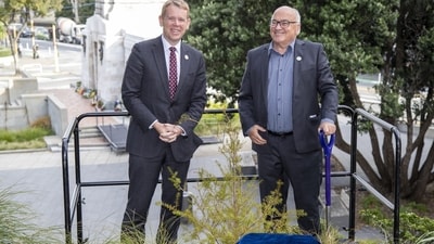 New Zealand Prime Minister Chris Hipkins, left, and and Project Crimson chairman Joris De Bres pose after planting a totara tree in Wellington. (AP) New Zealand Prime Minister Chris Hipkins, left, and and Project Crimson chairman Joris De Bres pose after planting a totara tree in Wellington. (AP)
