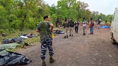 Security personnel at the site after at least ten police personnel and a driver were killed in a blast carried out by Naxalites in Chhattisgarh's Dantewada. (PTI)