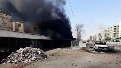 This handout photo shows smoke rising from a building next to a damaged car on a street in Khartoum. (AFP) This handout photo shows smoke rising from a building next to a damaged car on a street in Khartoum. (AFP)
