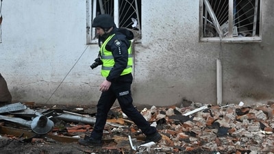 Russia-Ukraine War: A Ukrainian policeman walks next to the local history museum destroyed following Russian missile strike in the town of Kupiansk, Kharkiv region. (AFP) Russia-Ukraine War: A Ukrainian policeman walks next to the local history museum destroyed following Russian missile strike in the town of Kupiansk, Kharkiv region. (AFP)