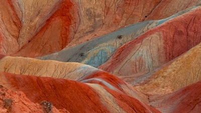 Zhangye Danxia Landform, China: These colourful mountains are a result of millions of years of mineral deposits, giving them a striped and surreal appearance.&nbsp; (Unsplash)