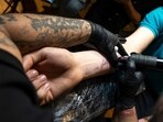 The mother and the stepfather allegedly tied down their children, 9- and 5-year-old, and forcibly pressed the needle into their skin for the tattoos.